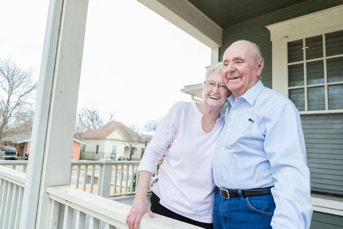 Older couple on porch hugging