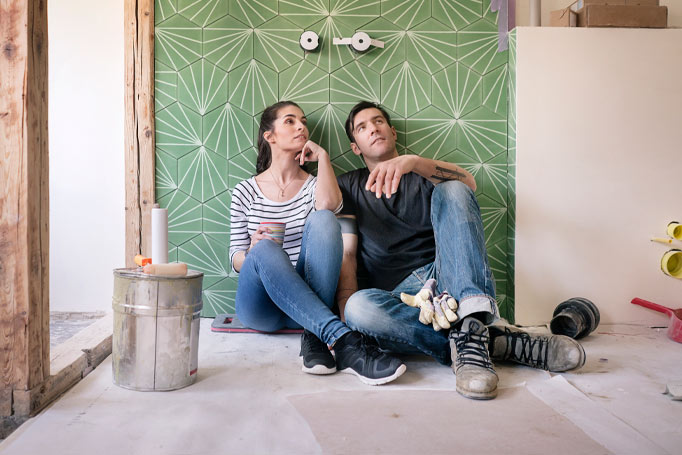 Couple sitting against the wall thinking