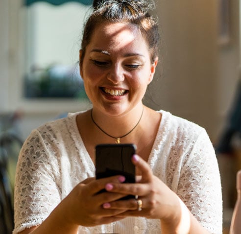 Woman smiling and texting on her phone