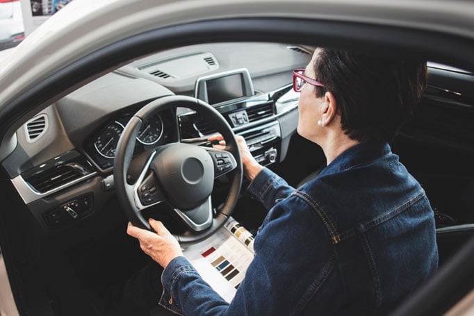 Woman sitting in driver's seat