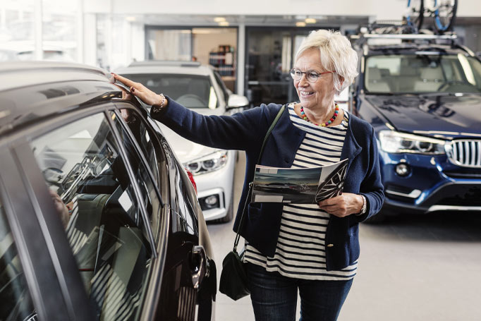 Woman looking at new car