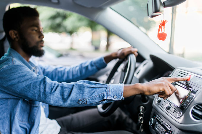 Man pressing button in his car