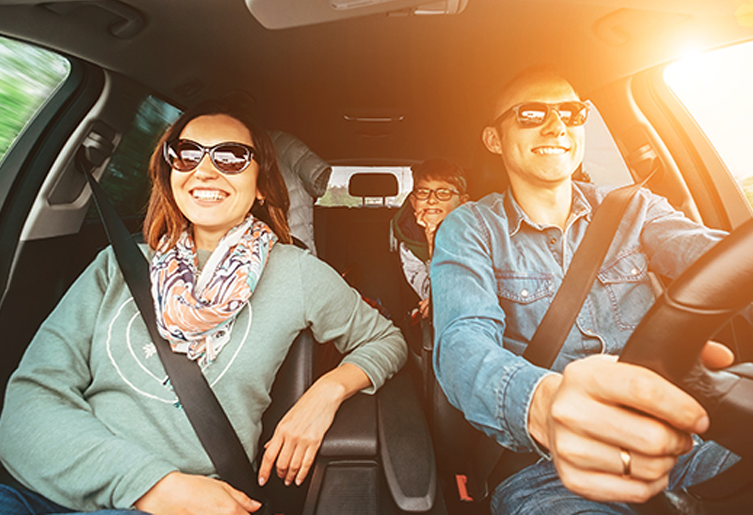 Family driving together and wearing sunglasses