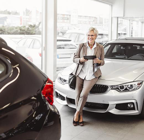 woman leaning against car