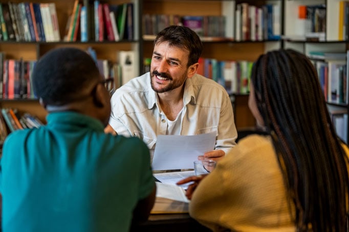 Two students in a meeting with a counselor