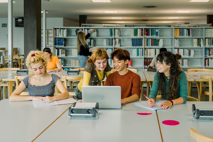 Four students working diligently at the library