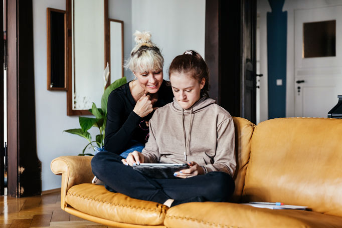 Mother and daughter looking at tablet together