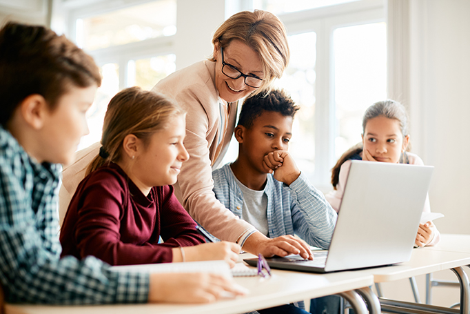 Teacher helping students