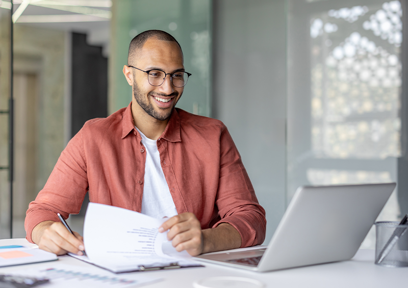man smiling at laptop
